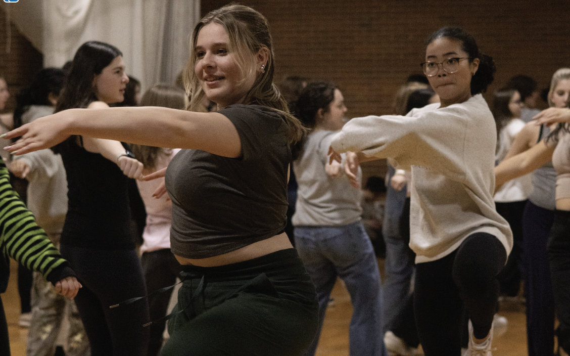 ALL THAT JAZZ: Seniors Vera Vassilyeva (left) and Mia Hermann (right), Featured Dancers, hit their spins along with other cast members in the dance studio. The Featured Dancers are the focal point of many dance numbers in Chicago.